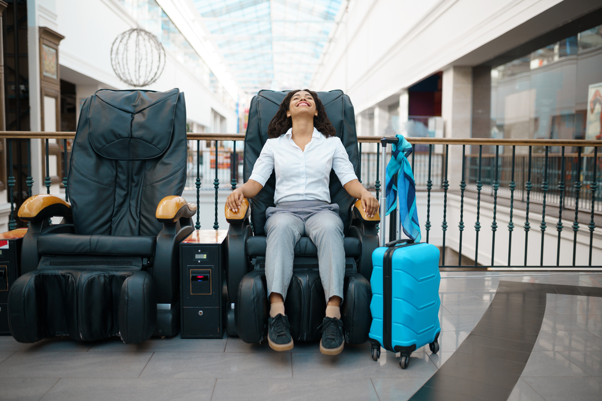 Girl with Suitcase Relax in Massage Chair, Airport